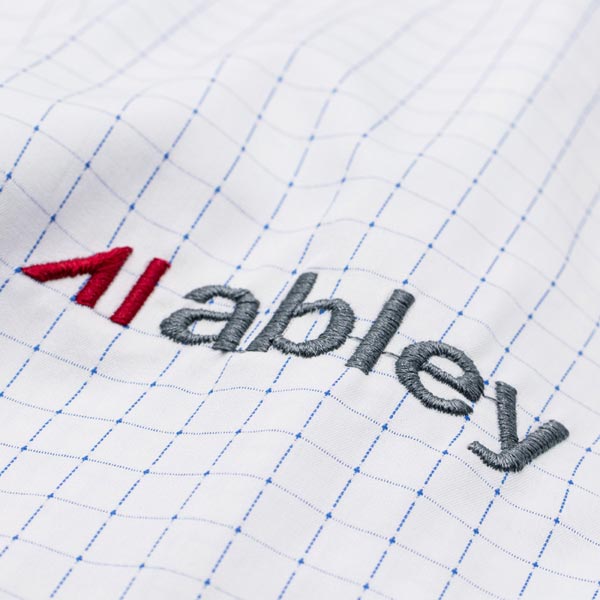 Close-up of embroidered corporate logo on a business shirt