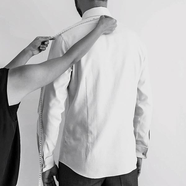 Uniform takes measurements for men’s corporate uniform